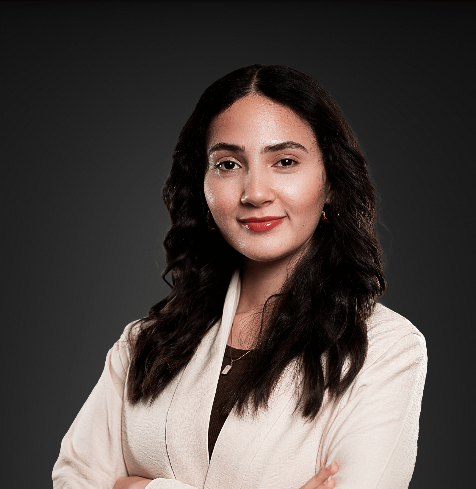 a woman with long black hair and a white jacket posed